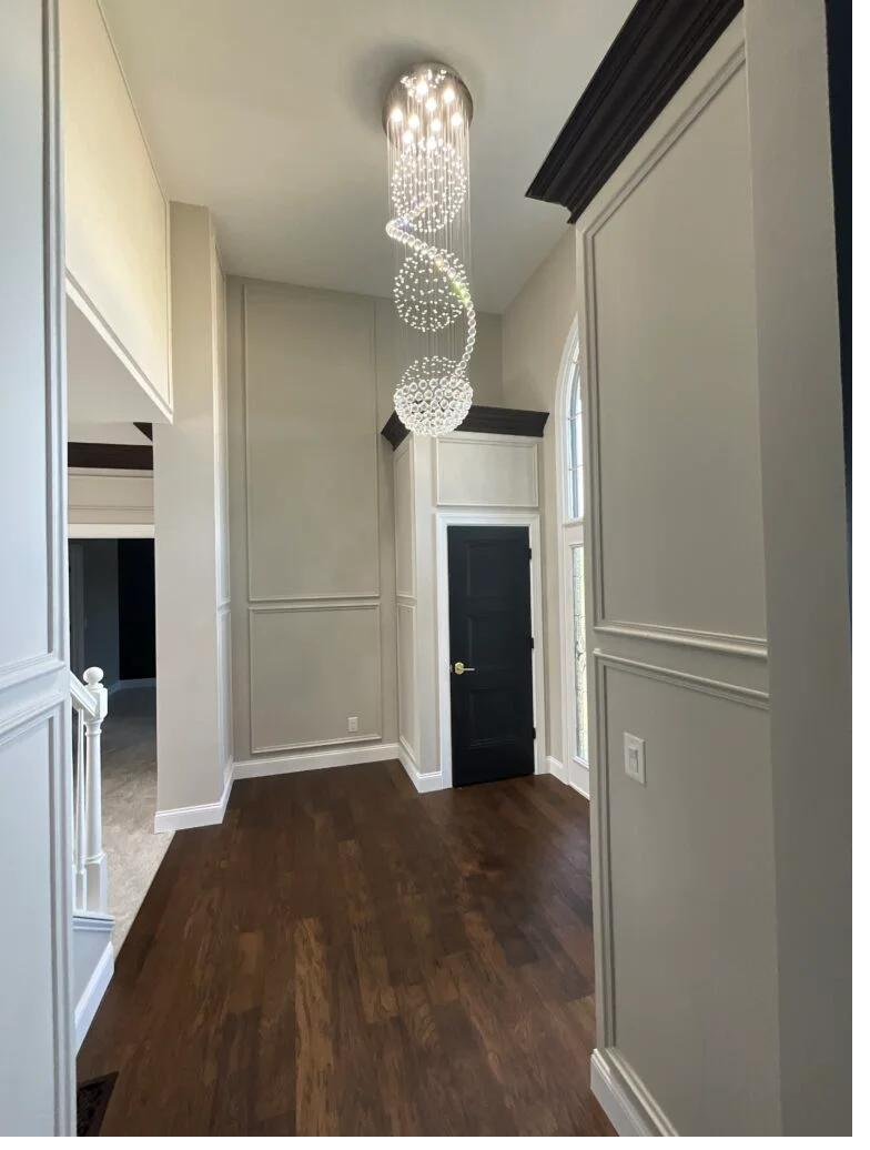Detailed finished hallway and chandelier
